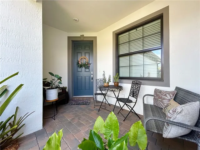 a kitchen with stainless steel appliances granite countertop a sink a stove a refrigerator with a dining table and chairs