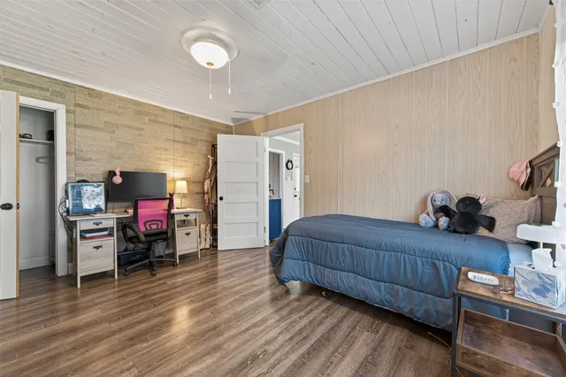 a bedroom with furniture and a wooden floor