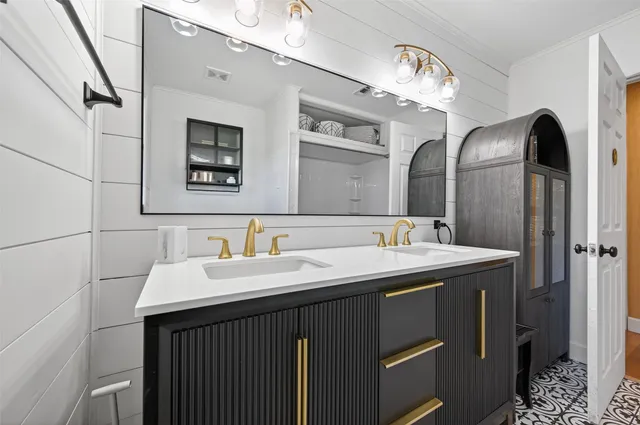 a bathroom with a double vanity sink and a mirror