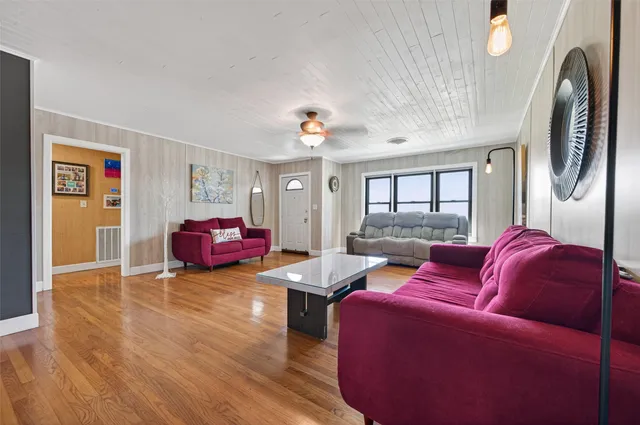 a living room with furniture and a chandelier