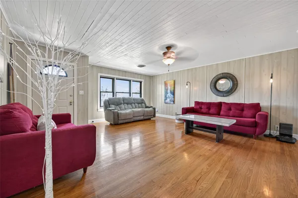 a living room with furniture a rug and a window