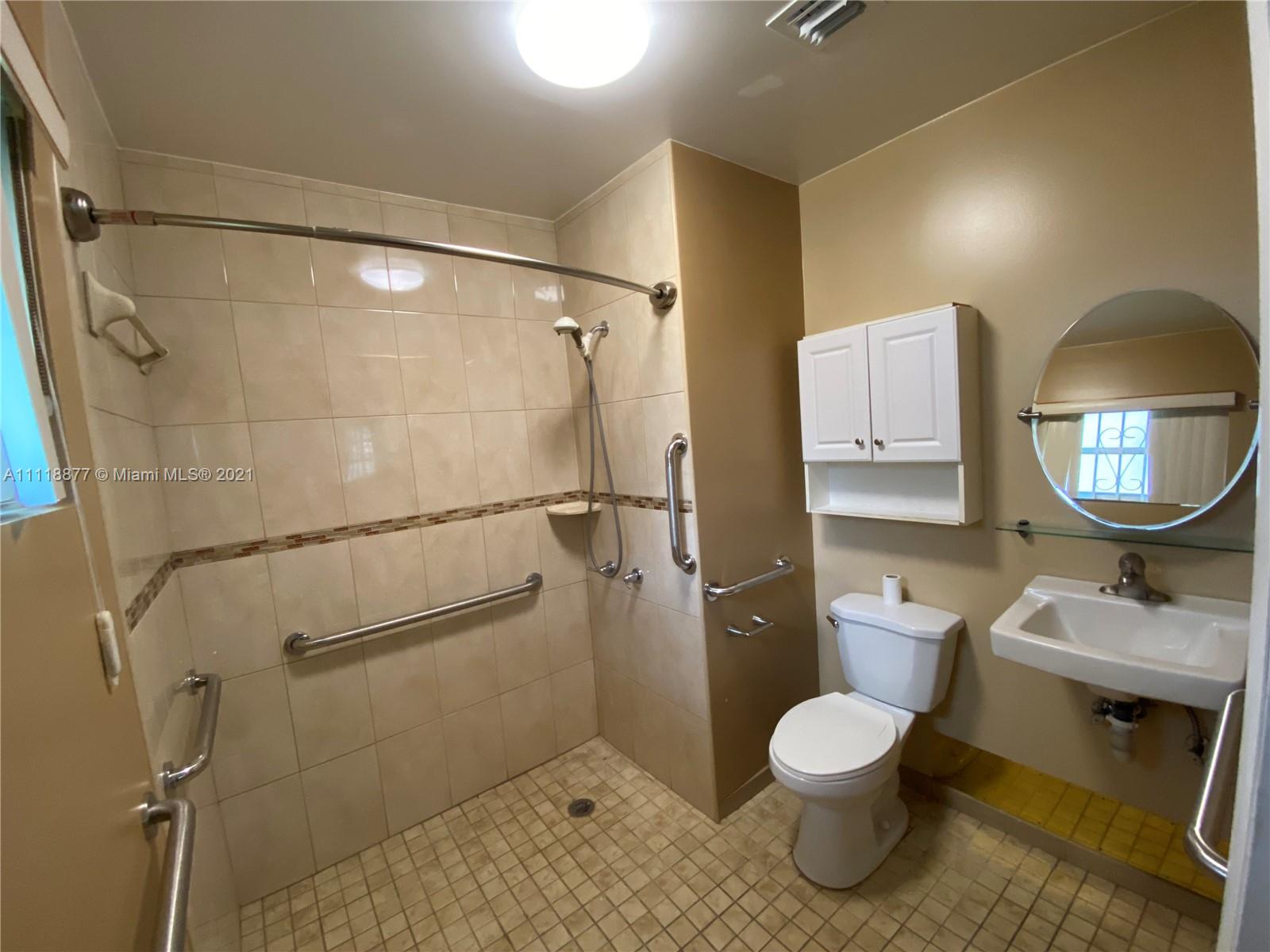 270 Northwest 50th Street Miami, FL 33127 - Photo 12 of 21 a bathroom with a toilet sink and a shower