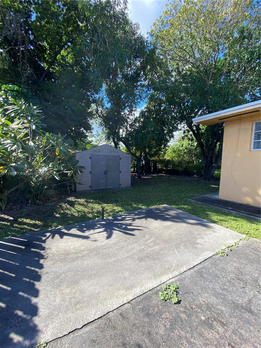 270 Northwest 50th Street Miami, FL 33127 - Photo 14 of 21 a wooden house with trees in front of it