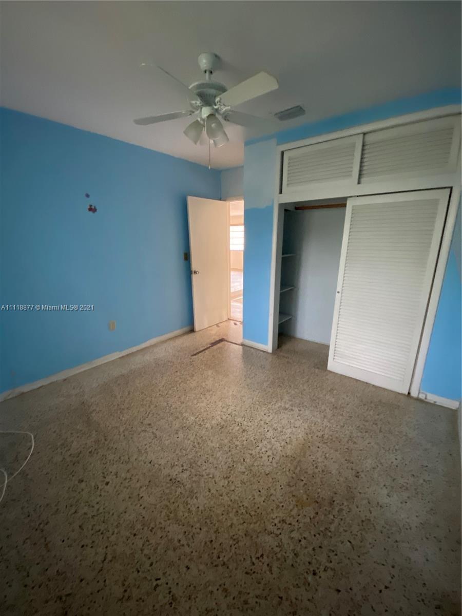 270 Northwest 50th Street Miami, FL 33127 - Photo 15 of 21 a view of an empty room with a chandelier fan