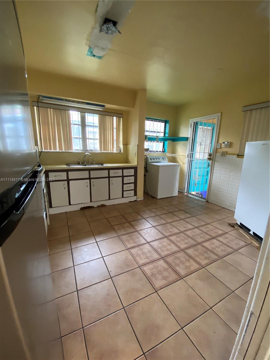 270 Northwest 50th Street Miami, FL 33127 - Photo 16 of 21 a view of a kitchen with furniture and a window
