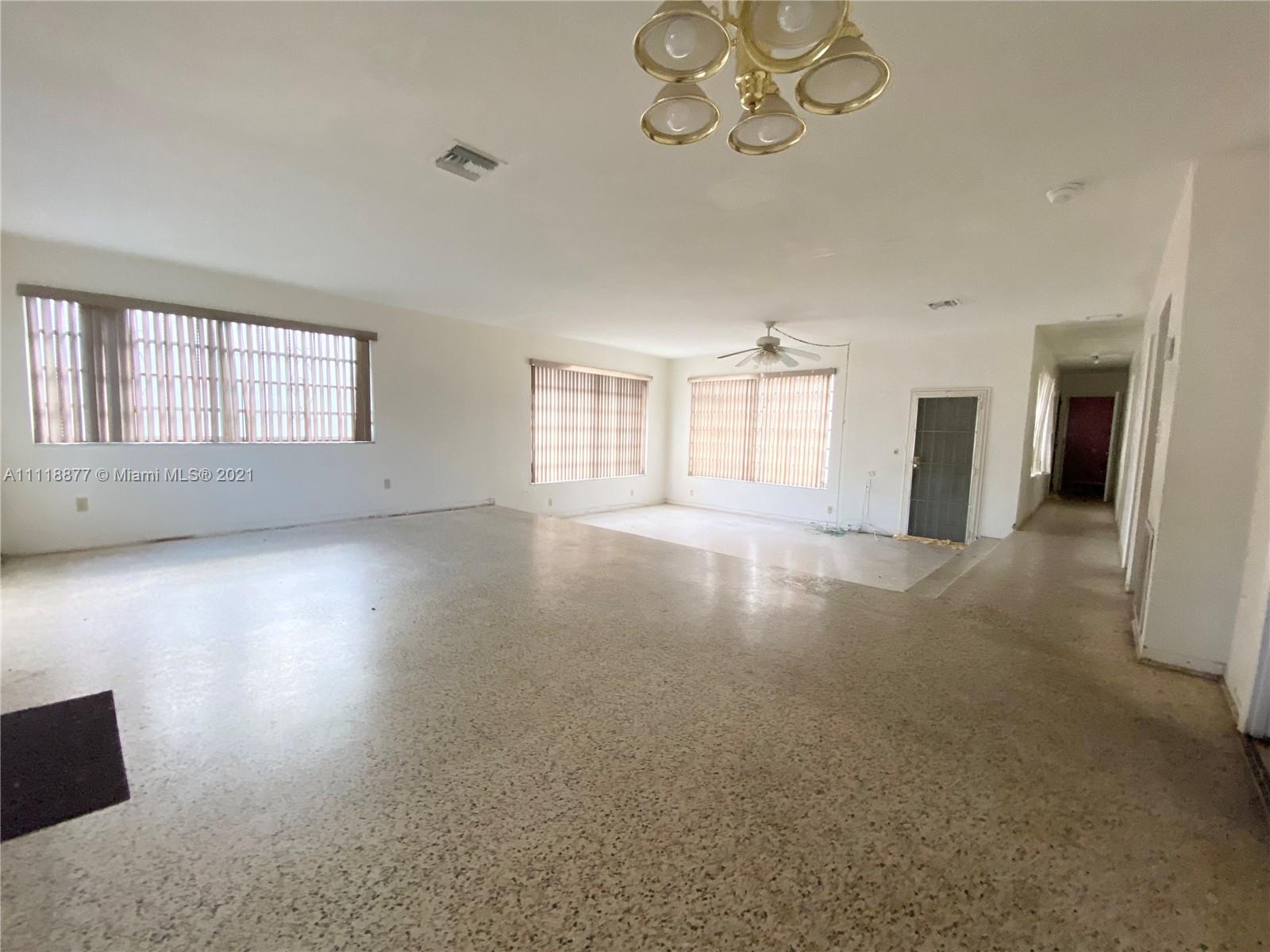 270 Northwest 50th Street Miami, FL 33127 - Photo 9 of 21 wooden floor in an empty room with a window