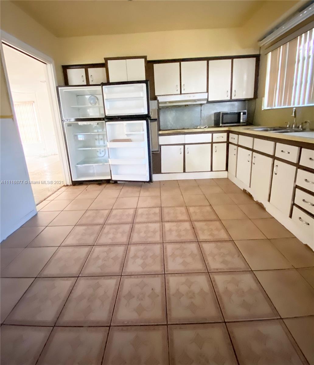 270 Northwest 50th Street Miami, FL 33127 - Photo 10 of 21 a view of a kitchen with furniture and window