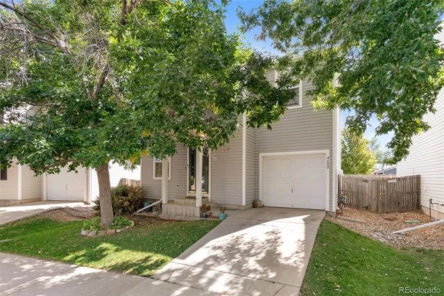 a house that has a tree in front of the house
