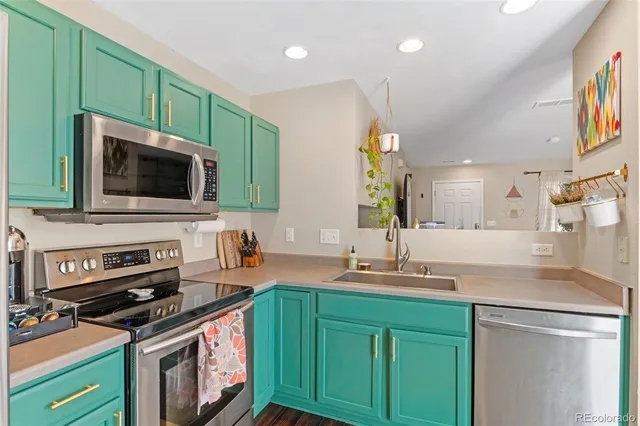 a kitchen with kitchen island a sink stove top oven and microwave
