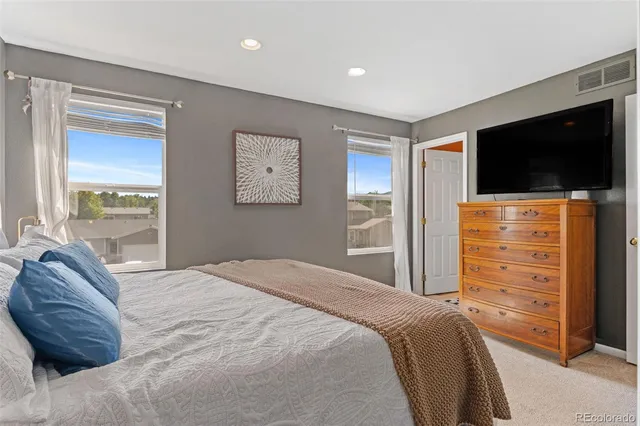 a bedroom with a bed and a television