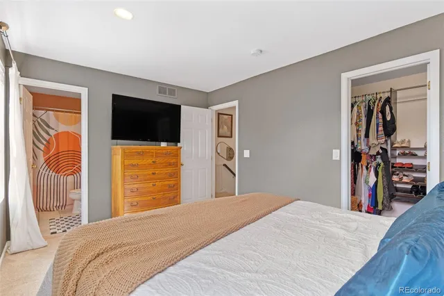 a bedroom with a bed and a flat tv screen