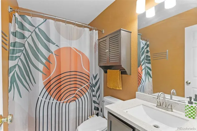 a bathroom with a sink a mirror and a shower