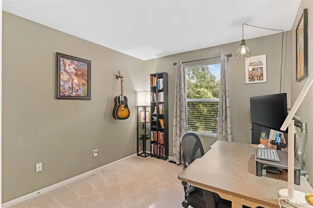 a view of a workspace with furniture and a flat screen tv
