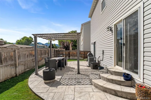a view of a patio with table and chairs potted plants with wooden floor