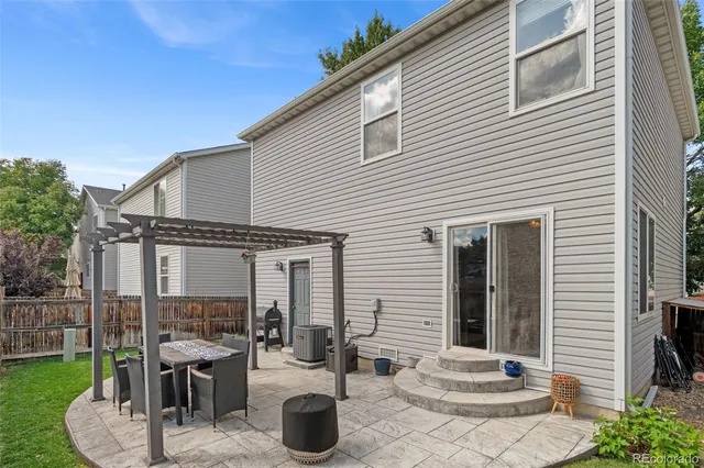 a view of a patio with table and chairs and potted plants
