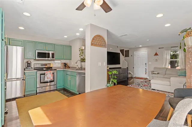 a kitchen with sink refrigerator and microwave
