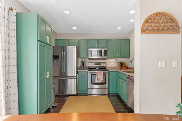 a kitchen with cabinets and stainless steel appliances