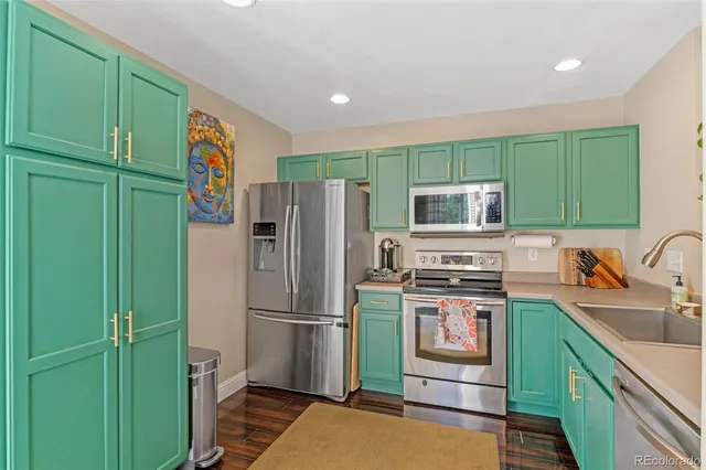 a kitchen with a refrigerator and a sink