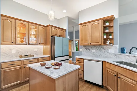 a kitchen with stainless steel appliances granite countertop a sink stove and refrigerator