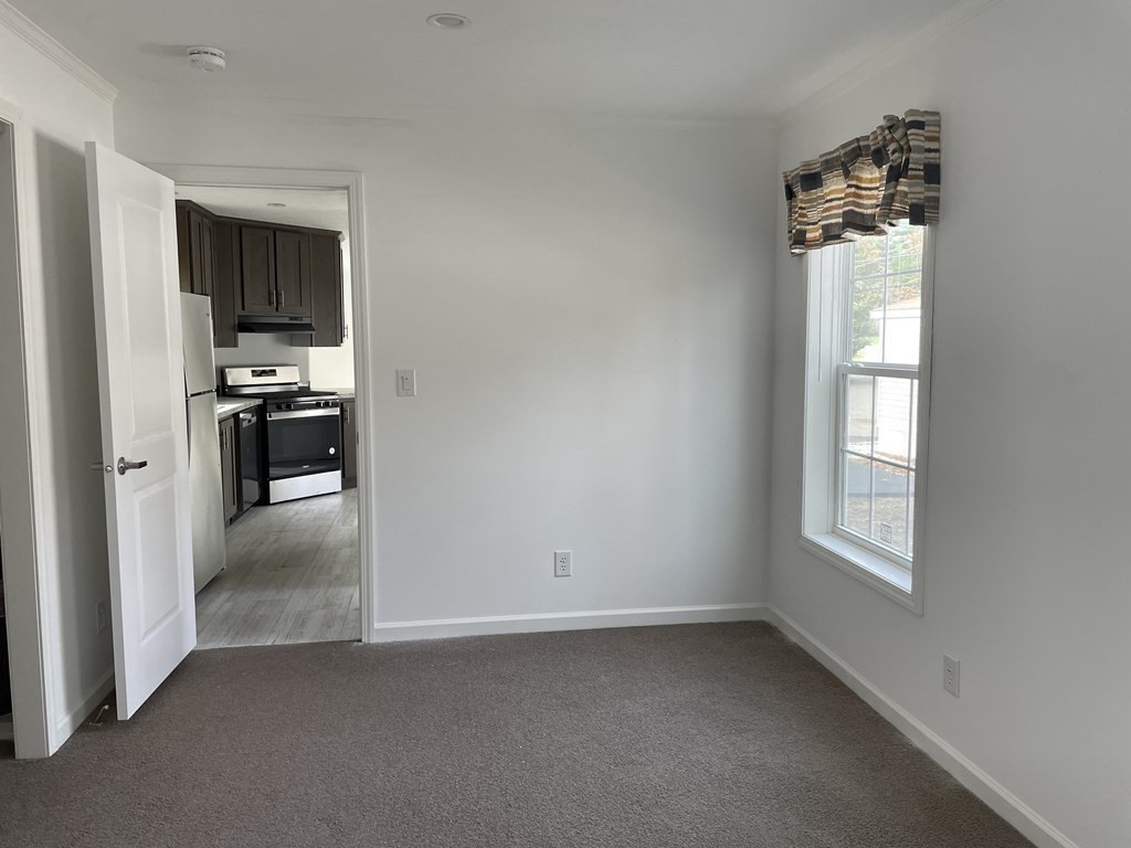 31 Holiday Road Holbrook, MA 02343 - Photo 7 of 12 an empty room with windows and cabinet