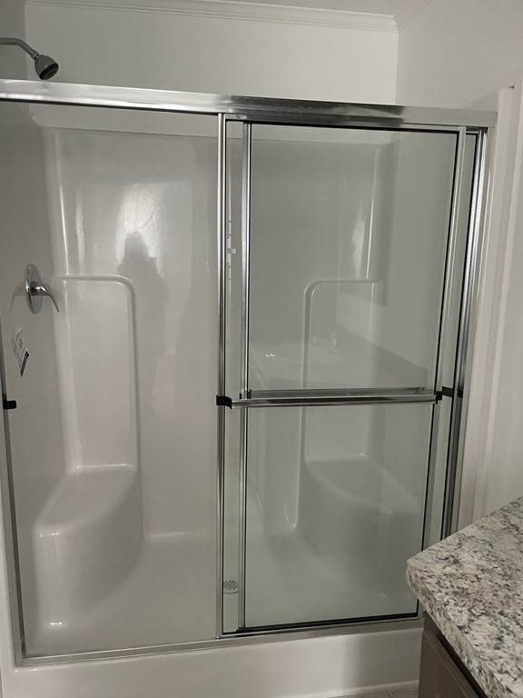 31 Holiday Road Holbrook, MA 02343 - Photo 9 of 12 a bathroom with a glass shower door