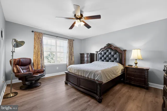 a spacious bedroom with a bed and a large window