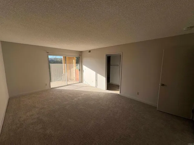 a view of a big house with a big yard plants and large trees