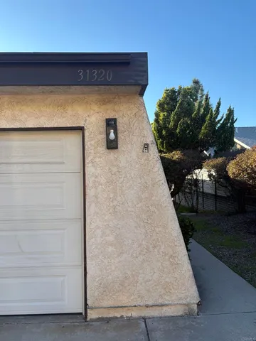 a wooden bench sitting in front of a house