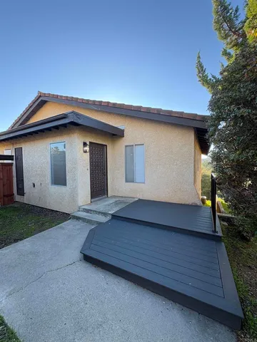 a view of empty room with wooden floor and fireplace