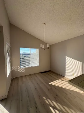 a view of a livingroom with an empty space and a fireplace