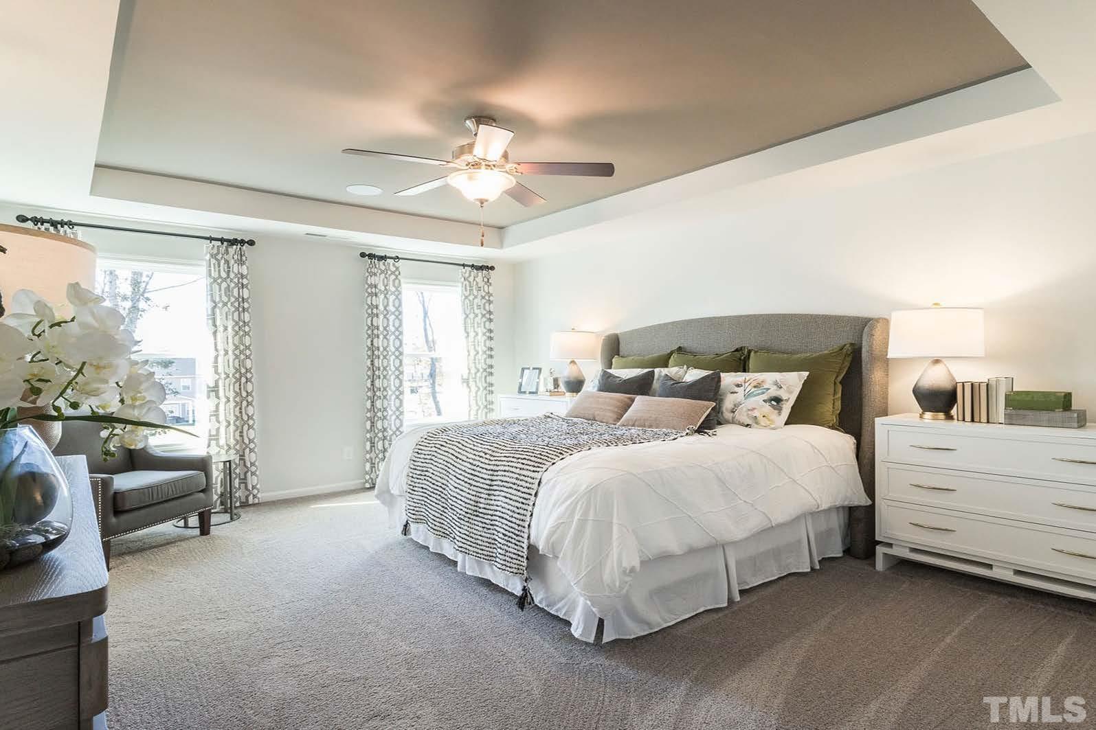 70 Roseshell Way Louisburg, NC 27549 - Photo 5 of 11 a spacious bedroom with a bed and a couch