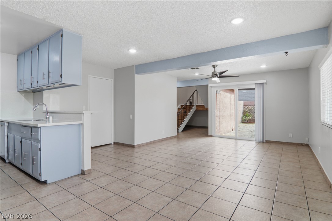 An open concept living area seamlessly connects the kitchen and main living space, leading to a private outdoor area.