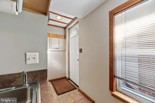a kitchen with stainless steel appliances granite countertop a sink stove refrigerator and cabinets
