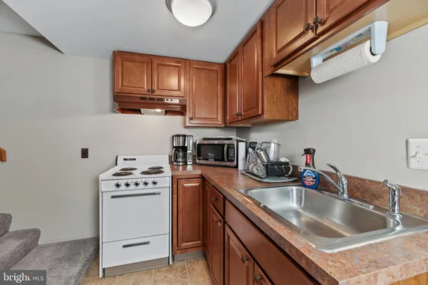 a bathroom with a shower a mirror and a sink