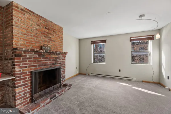 an empty room with furniture and a fireplace
