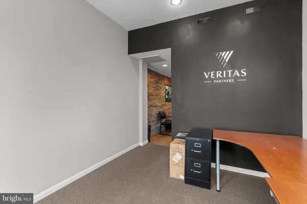 a living room with furniture a rug and white walls