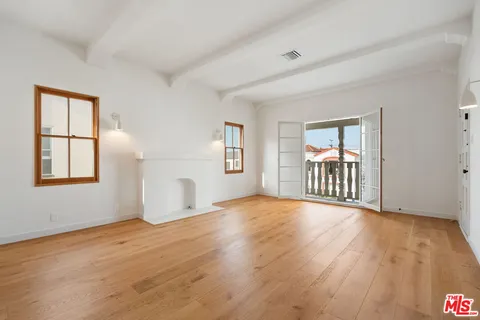 a view of a livingroom with a kitchen and a window