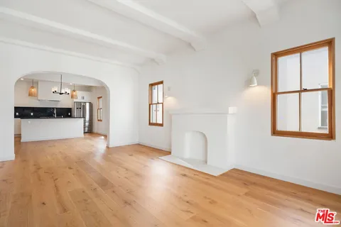 a kitchen with stainless steel appliances granite countertop a sink a stove and a refrigerator