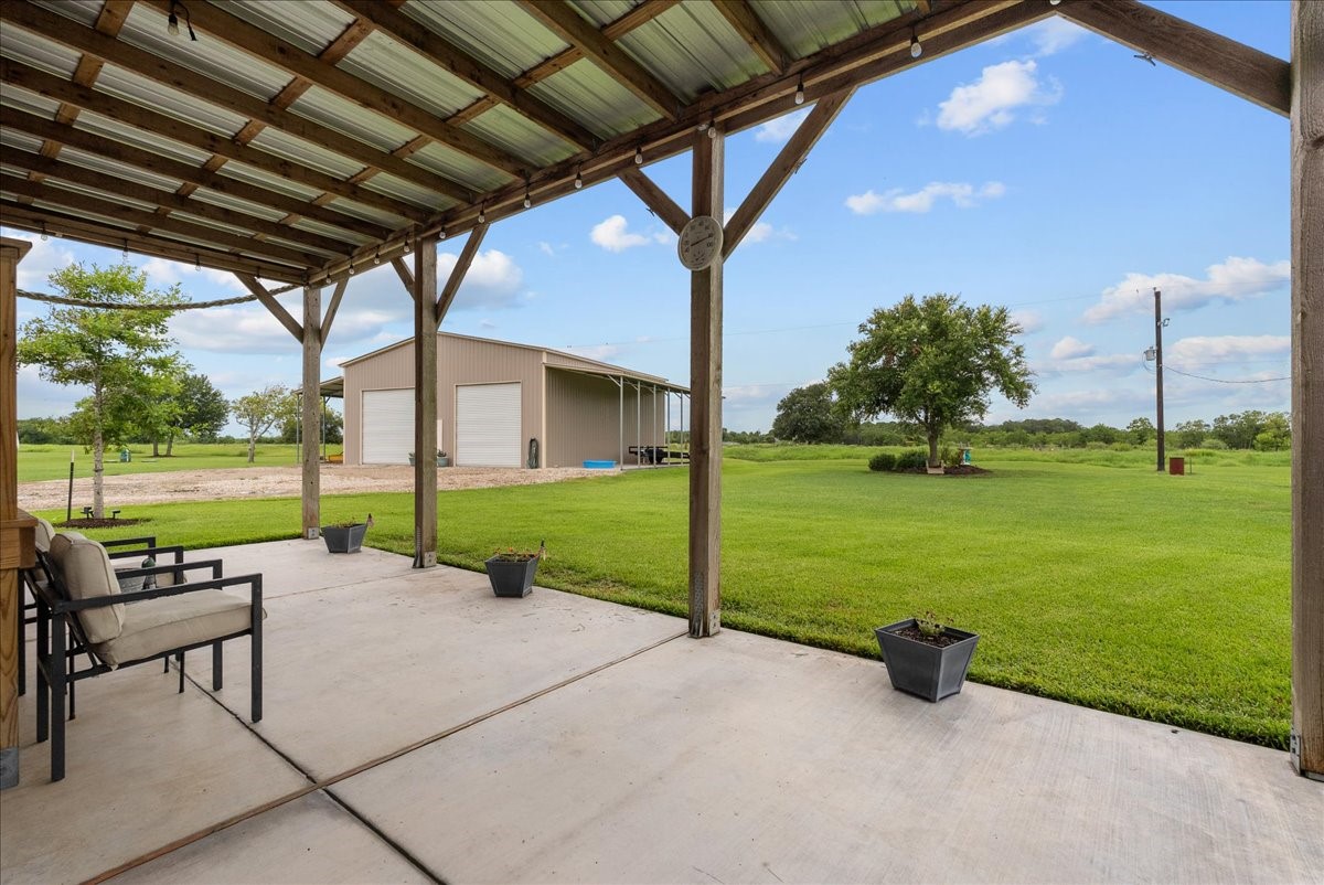 8710 Fm 646 Road South Santa Fe, TX 77510 - Photo 26 of 32 What a view of the backyard! The perfect spot with cover to enjoy your morning coffee, your favorite beverage, or relax with family and friends during gatherings