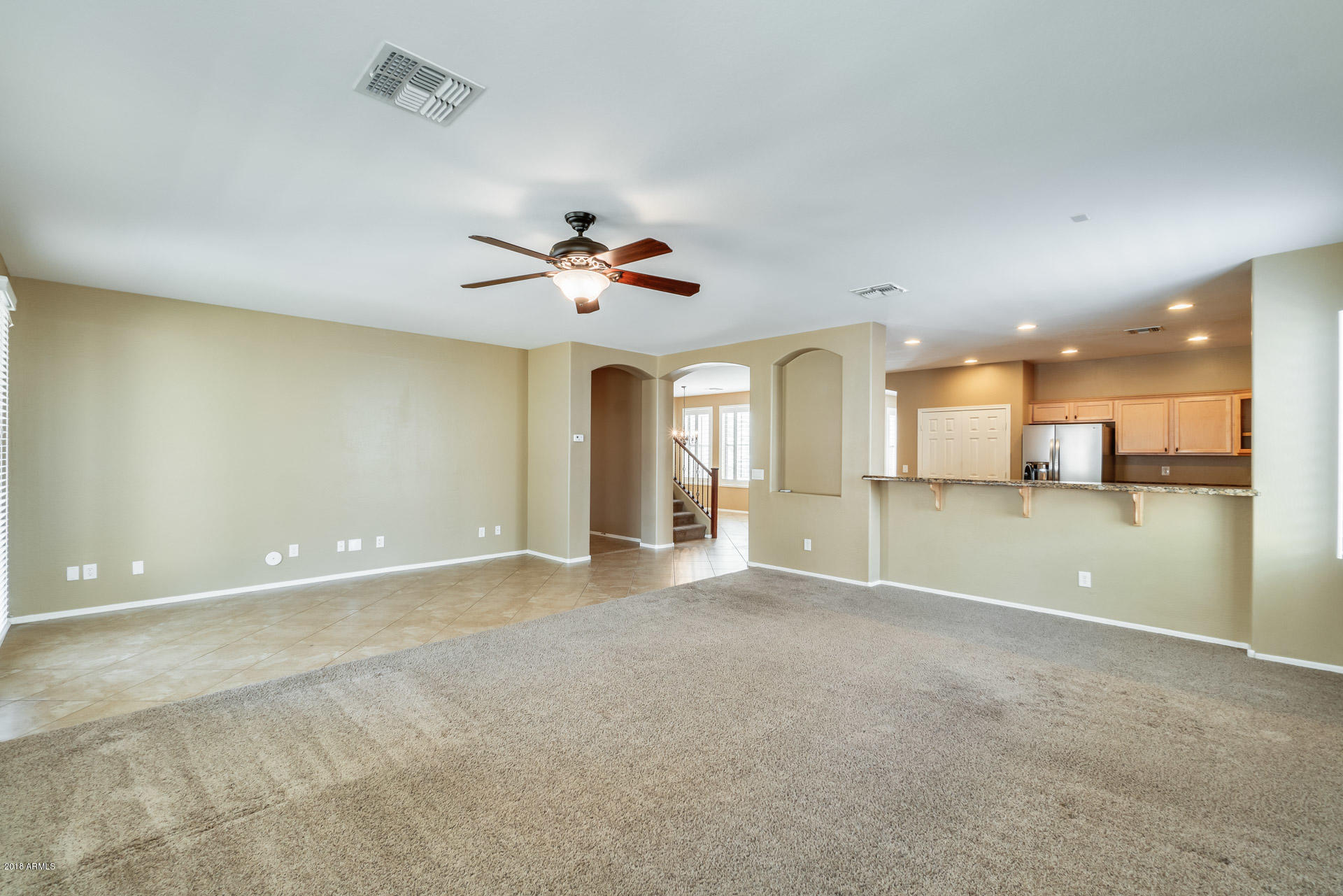3250 East Blue Ridge Way Gilbert, AZ 85298 - Photo 20 of 44 a view of an empty room with a kitchen