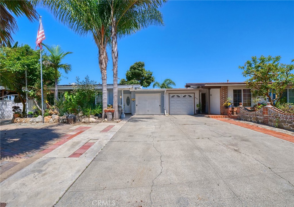 820 Raintree Place Vista, CA 92084 - Photo 1 of 29 a view of a white house with a yard and palm trees