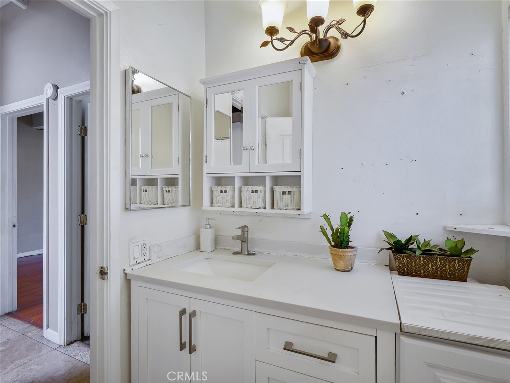 820 Raintree Place Vista, CA 92084 - Photo 14 of 29 a bathroom with a sink a potted plant and a window