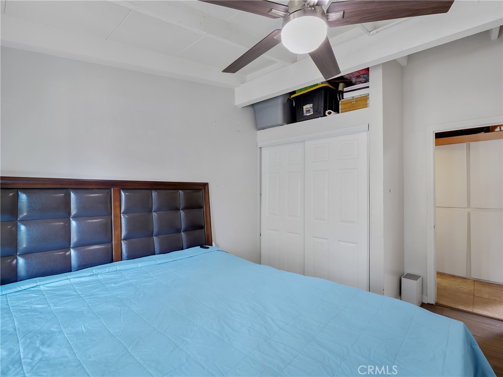 820 Raintree Place Vista, CA 92084 - Photo 20 of 29 a bedroom with a bed and a chandelier