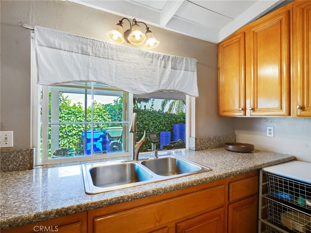 820 Raintree Place Vista, CA 92084 - Photo 5 of 29 a kitchen with a sink and large window