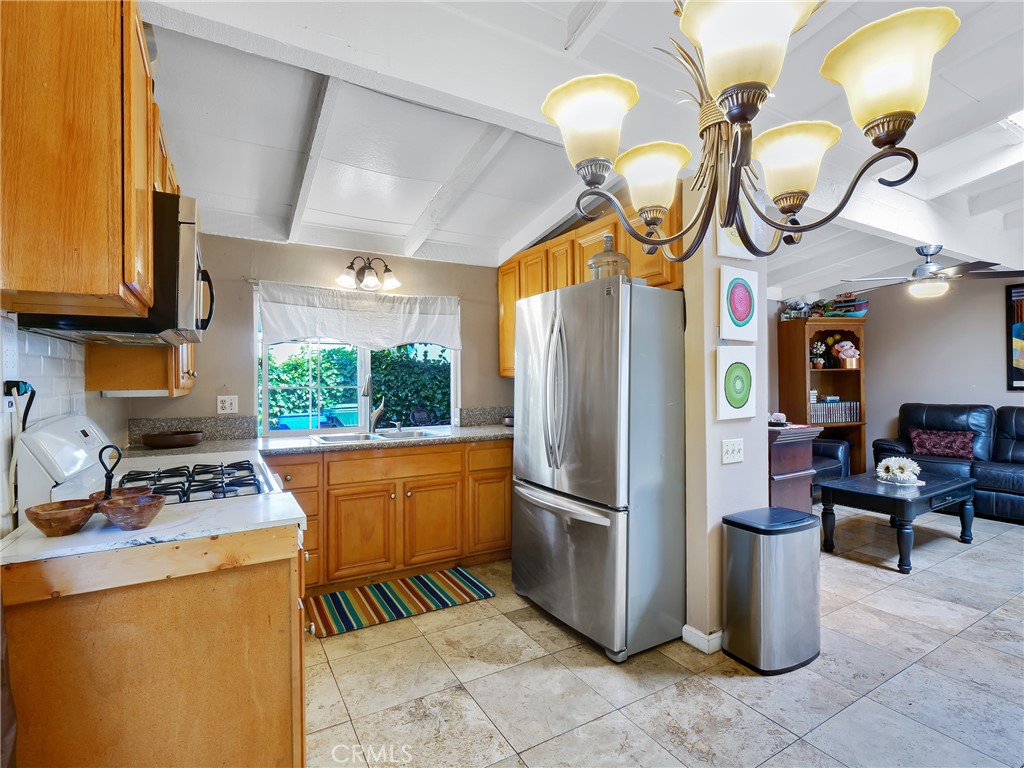 820 Raintree Place Vista, CA 92084 - Photo 6 of 29 a kitchen with stainless steel appliances granite countertop a sink a stove and a refrigerator