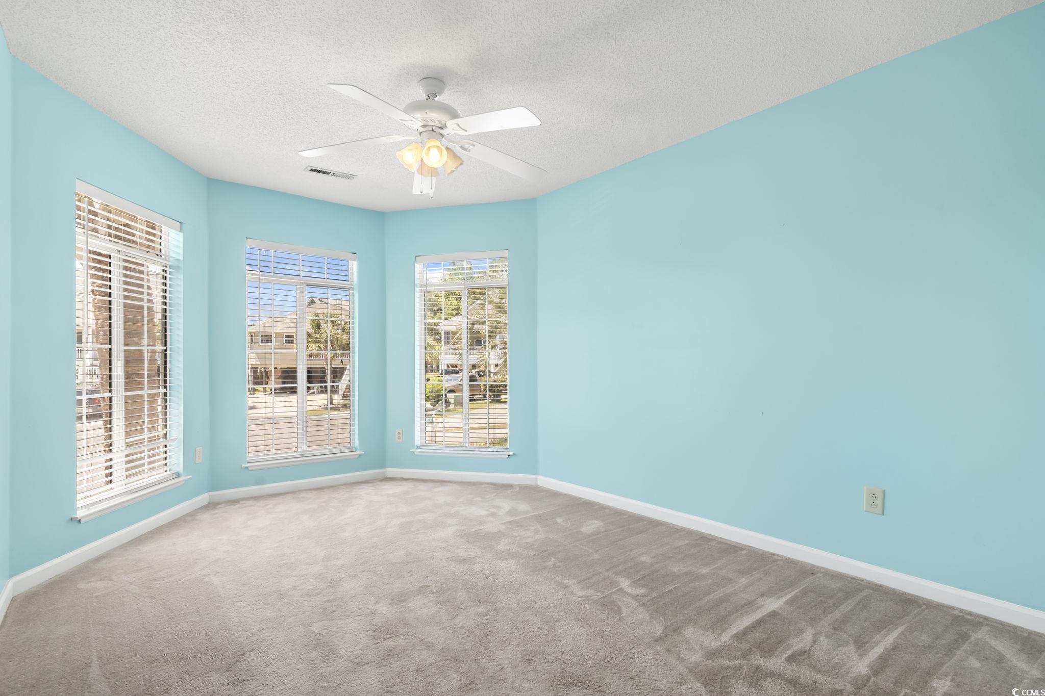 914 Dock Place Murrells Inlet, SC 29576 - Photo 23 of 37 Carpeted empty room with a textured ceiling, a ceiling fan, and baseboards