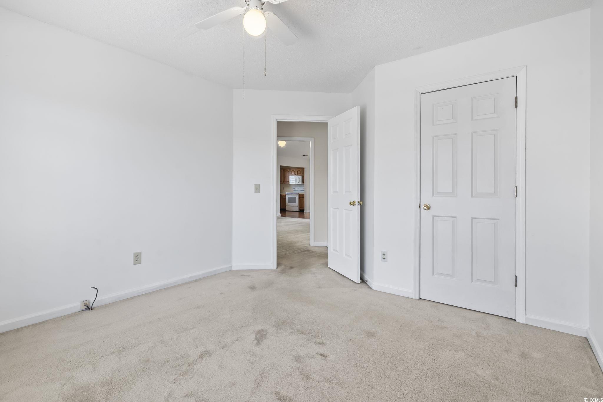 914 Dock Place Murrells Inlet, SC 29576 - Photo 26 of 37 Unfurnished bedroom with carpet flooring, baseboards, and a ceiling fan