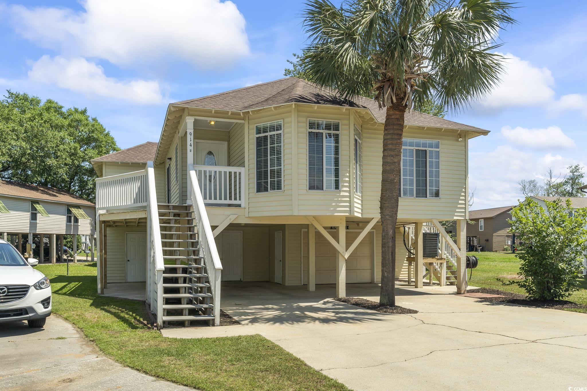 914 Dock Place Murrells Inlet, SC 29576 - Photo 3 of 37 Beach home with stairs, a carport, driveway, a shingled roof, and cooling unit