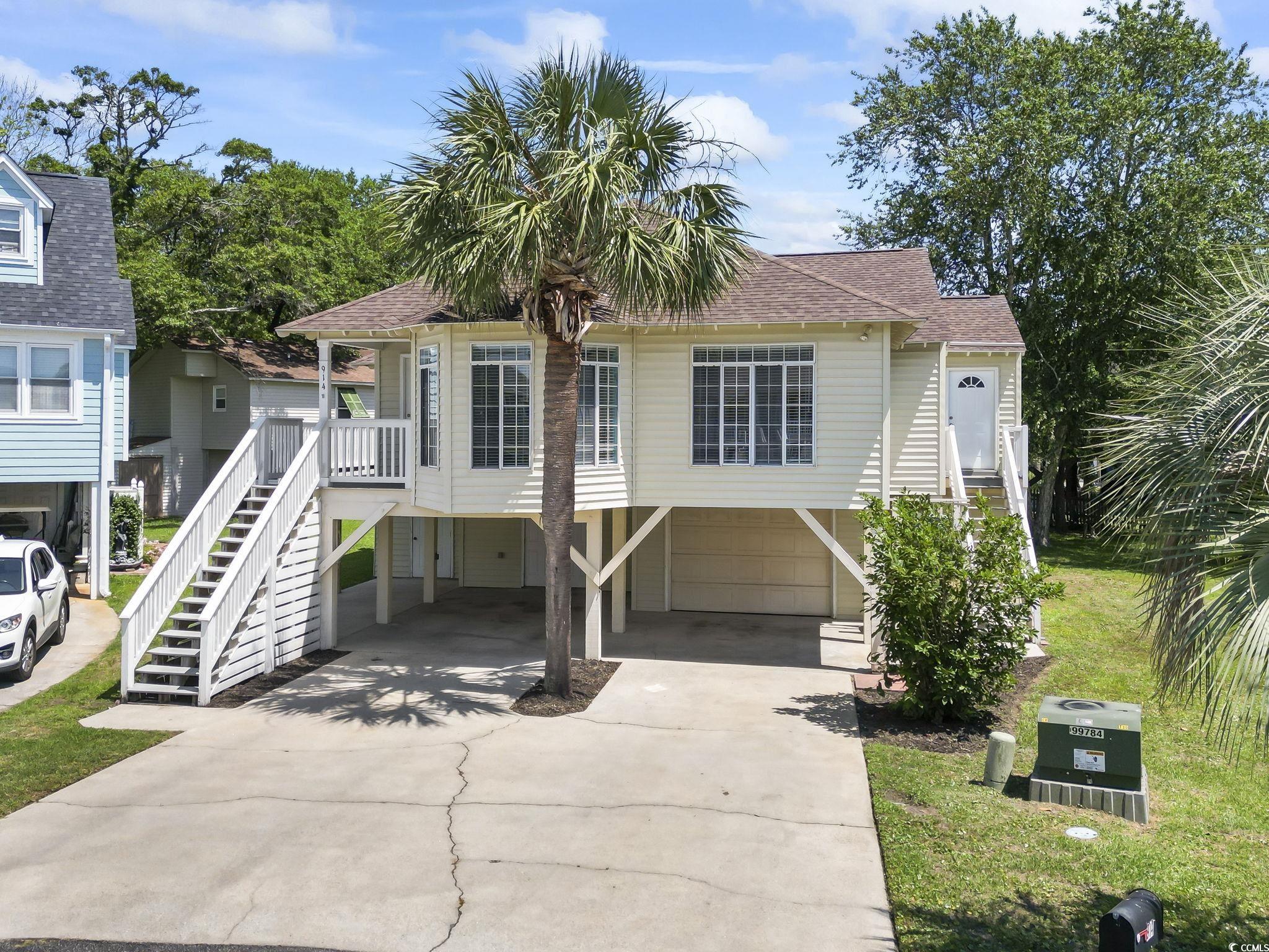 914 Dock Place Murrells Inlet, SC 29576 - Photo 4 of 37 Beach home featuring stairway, driveway, a carport, and a shingled roof
