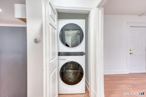 a close view of a utility room with dryer and washer